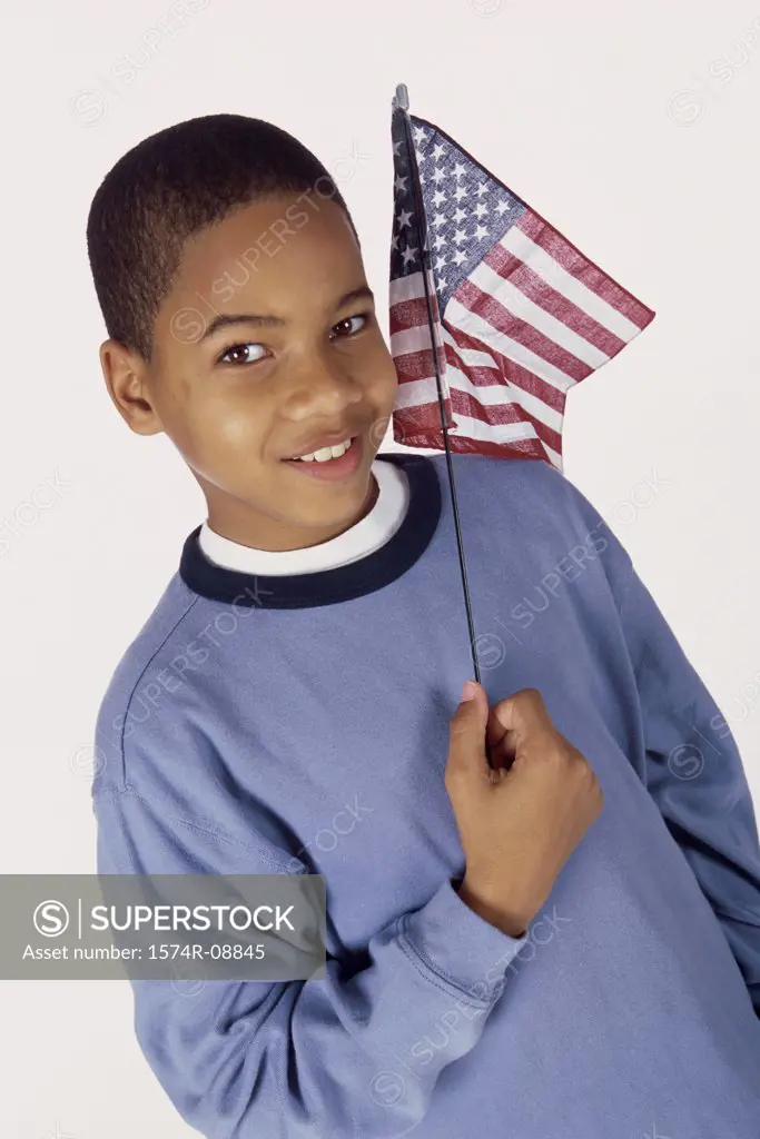Portrait of a boy holding an American flag