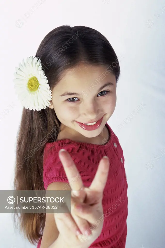 Portrait of a girl showing victory sign