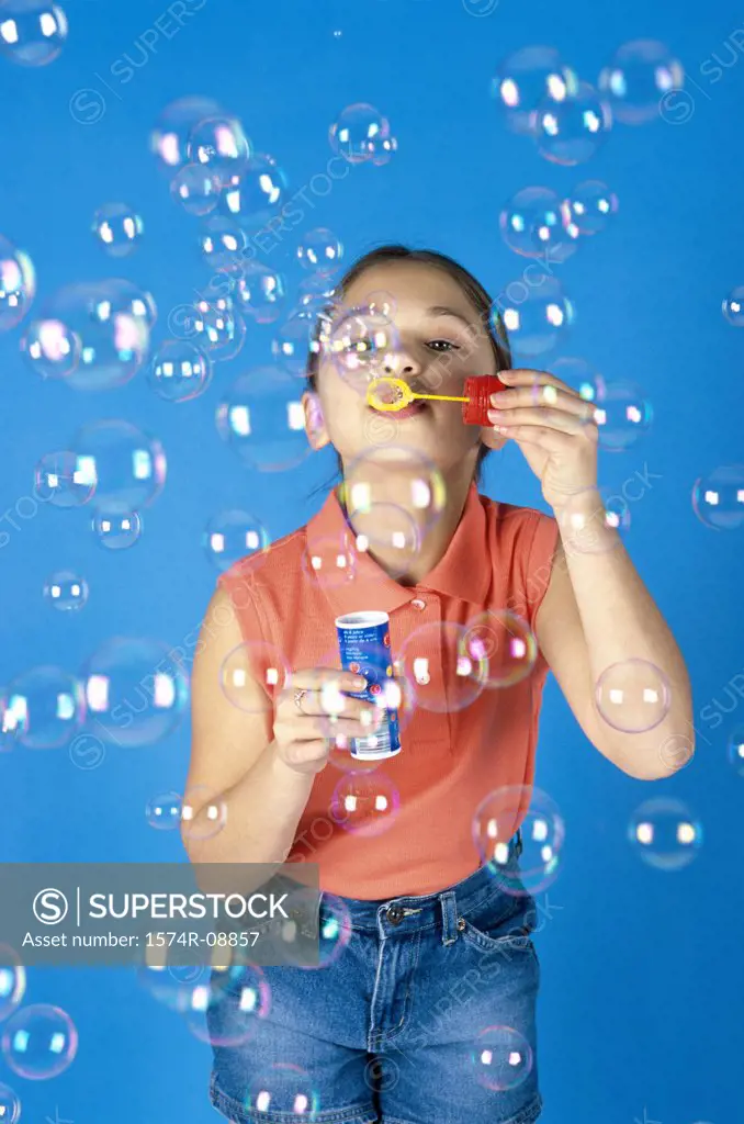 Portrait of a girl blowing soap bubbles