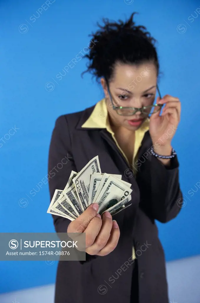Young woman looking at paper money