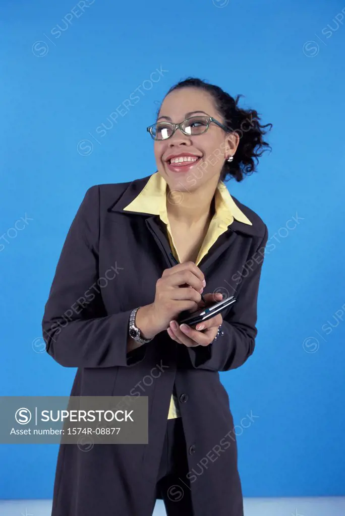 Young businesswoman smiling holding a hand held device