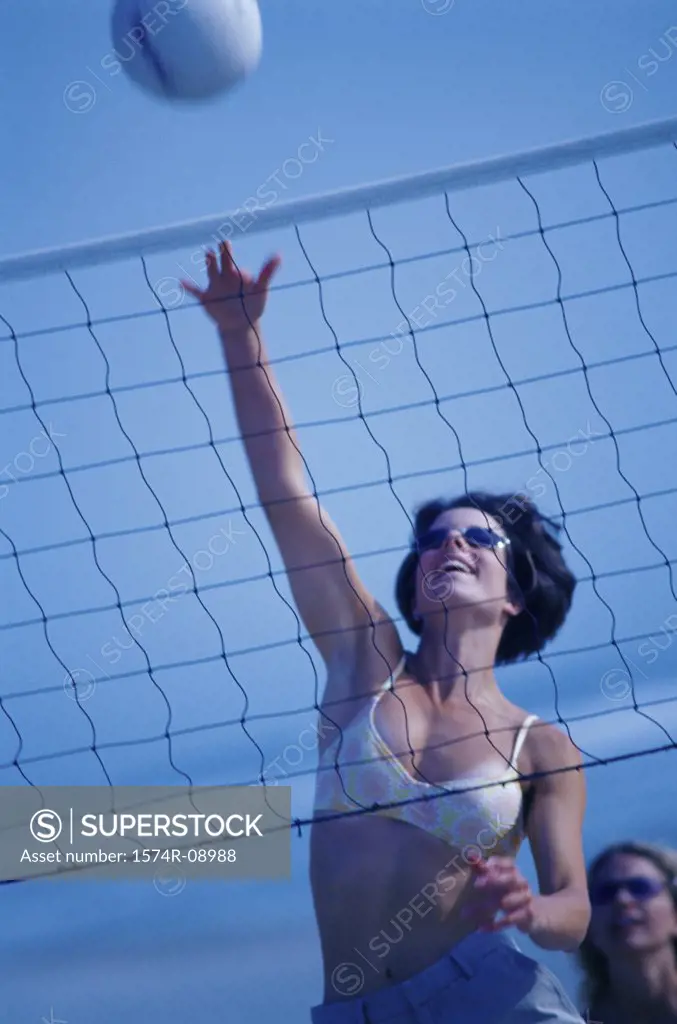 Young woman playing beach volleyball