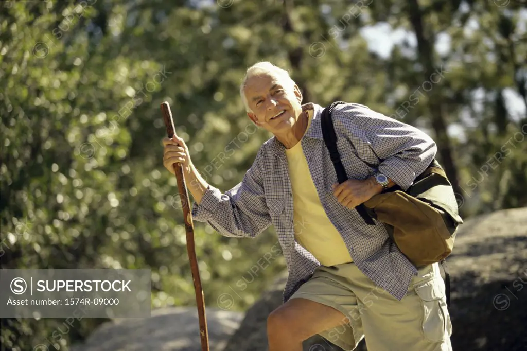 Portrait of a senior man holding a hiking pole