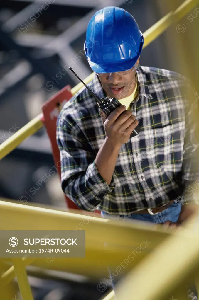 Construction worker talking on a walkie-talkie
