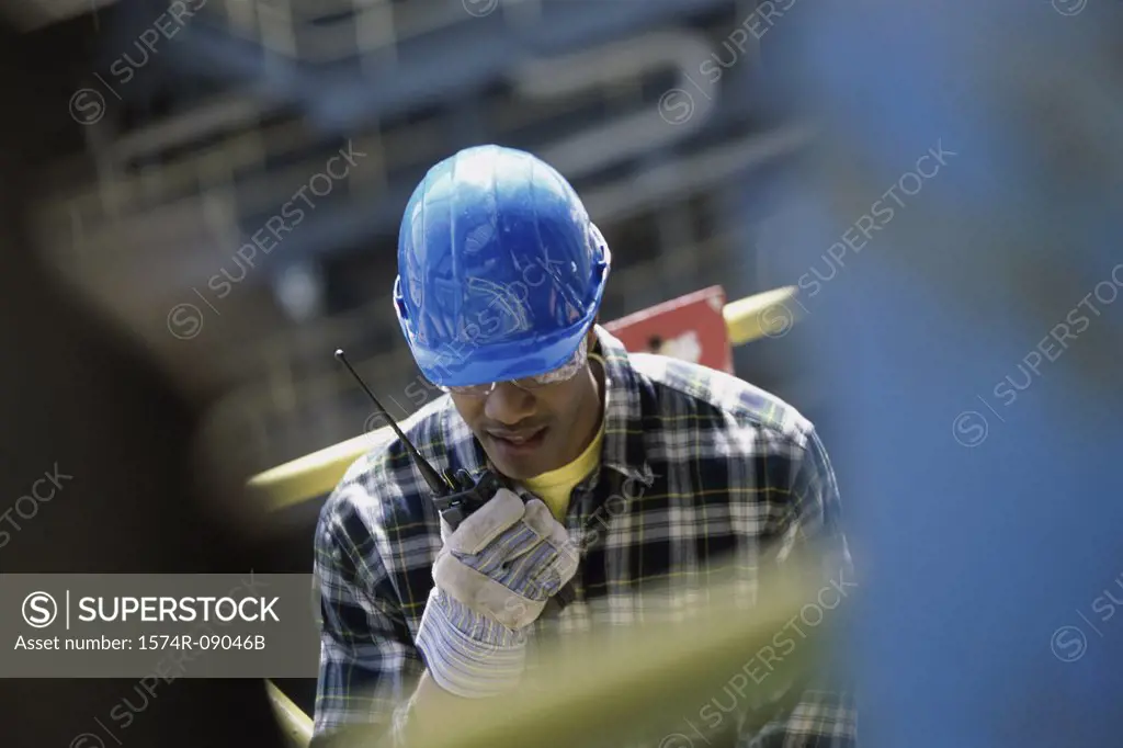 Construction worker talking on a walkie-talkie