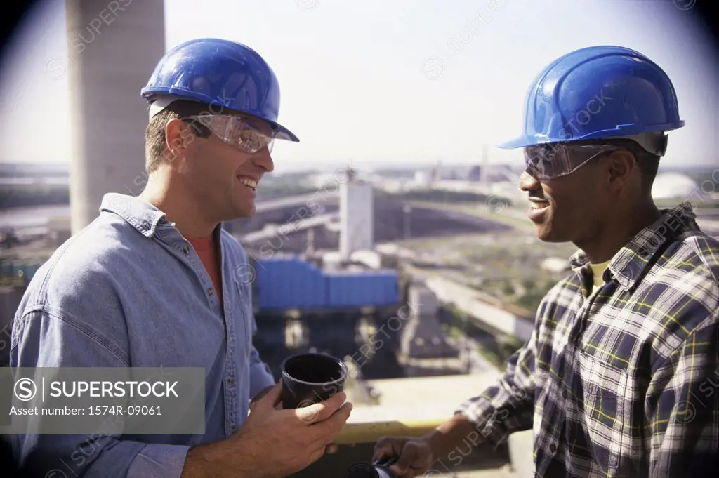 Two construction workers having a coffee break