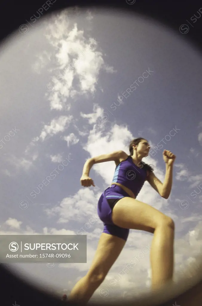 Low angle view of a young woman running