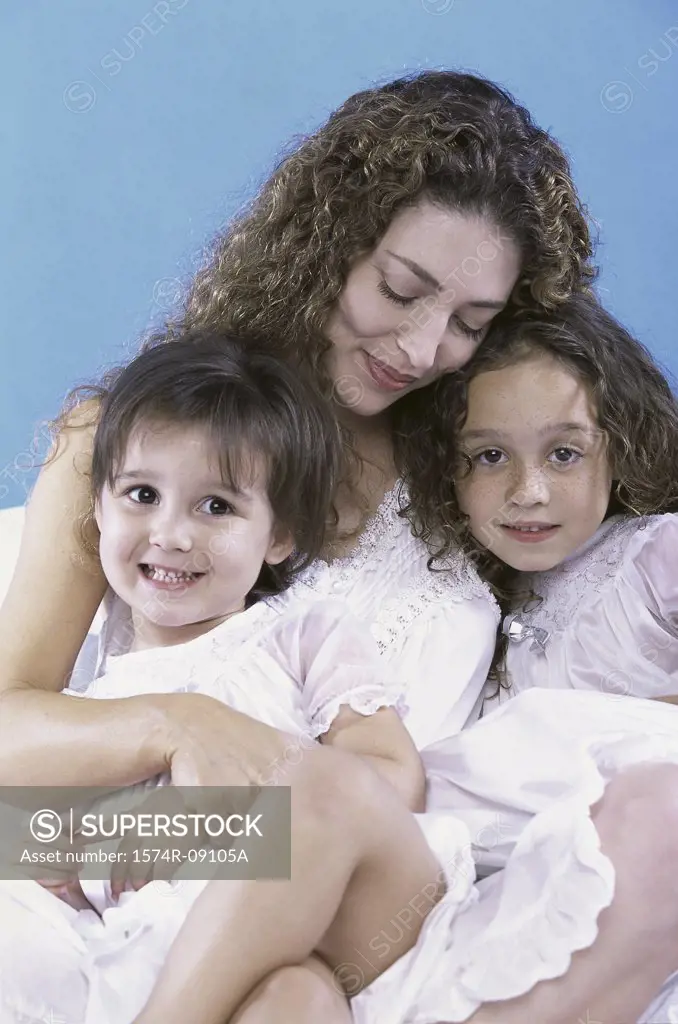 Mother holding her two daughters