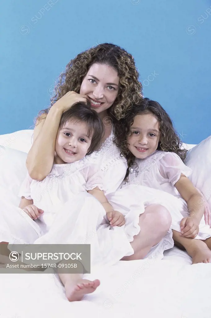 Portrait of a mother holding her two daughters