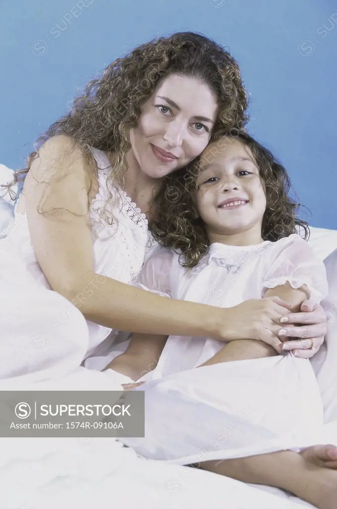 Portrait of a mother holding her daughter