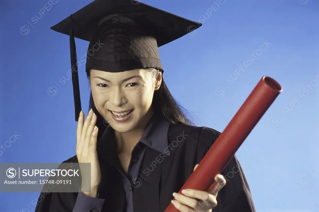 Portrait of a young female graduate holding a diploma