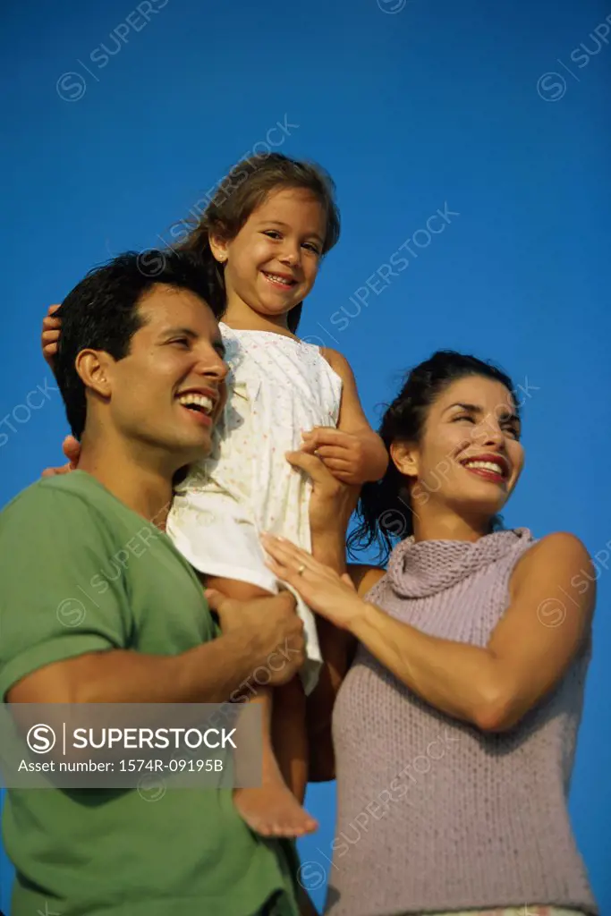 Low angle view of a mother and father with their daughter