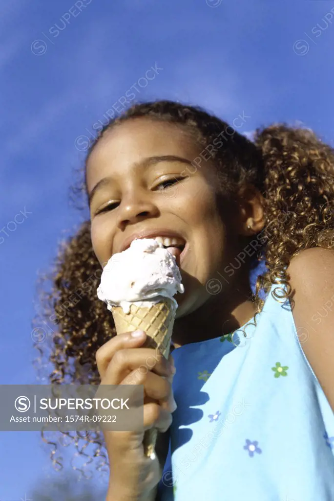 Low angle view of a girl eating an ice cream