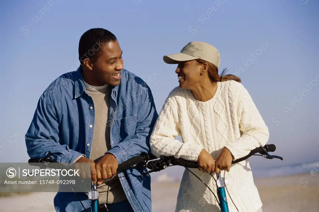 Young couple on bicycles at the beach