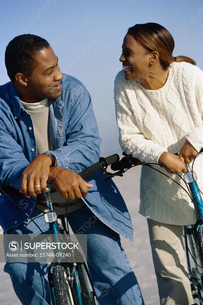 Young couple on bicycles at the beach