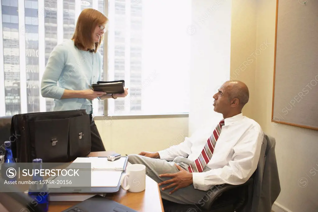Businessman talking to his secretary in an office