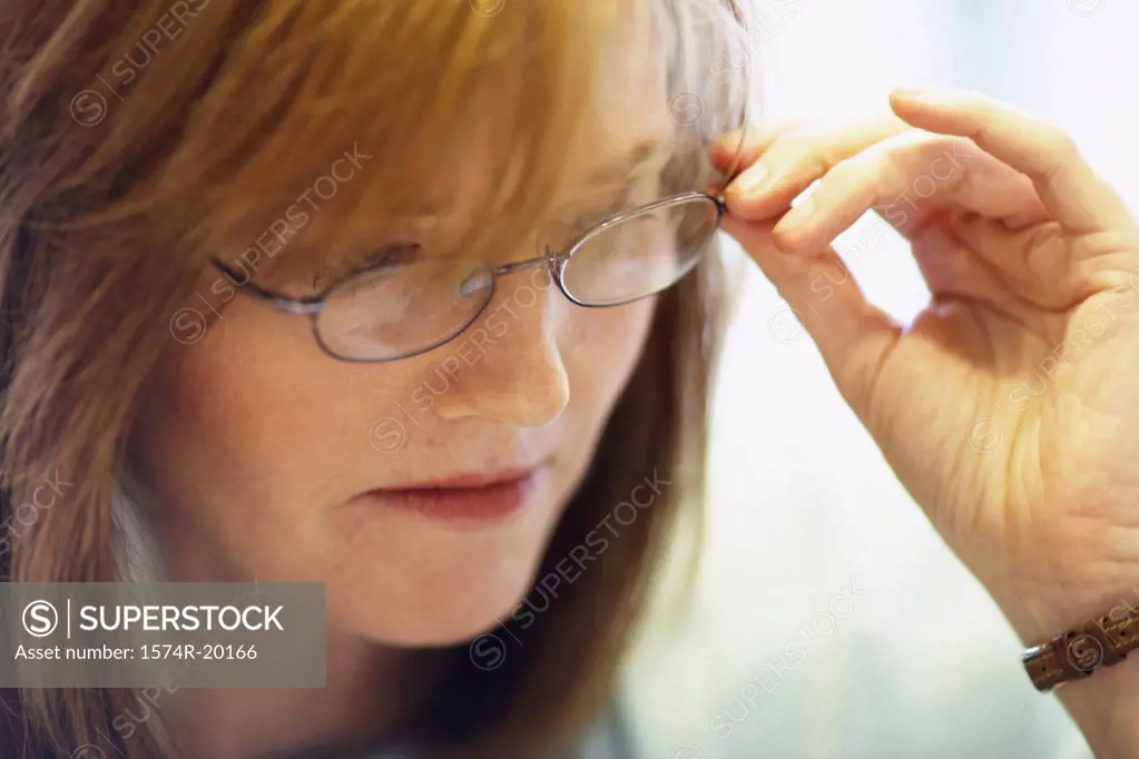 Close-up of a businesswoman holding a pair of eyeglasses