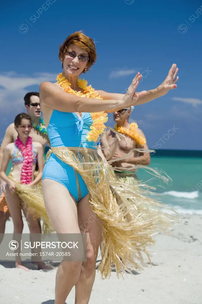 Senior woman hula dancing on the beach