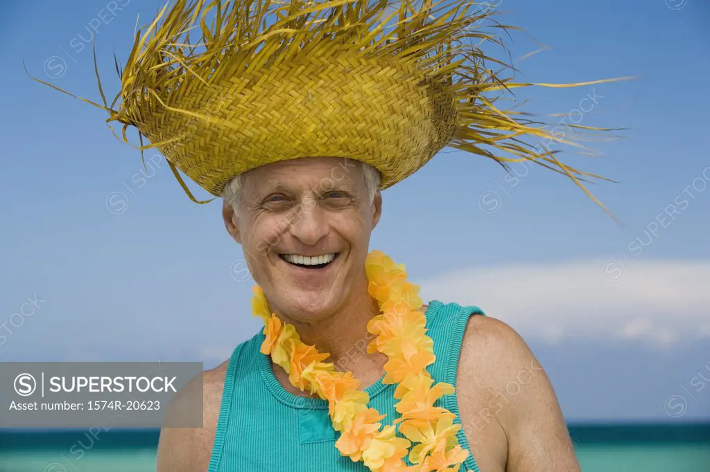 Portrait of a senior man wearing a straw hat and smiling