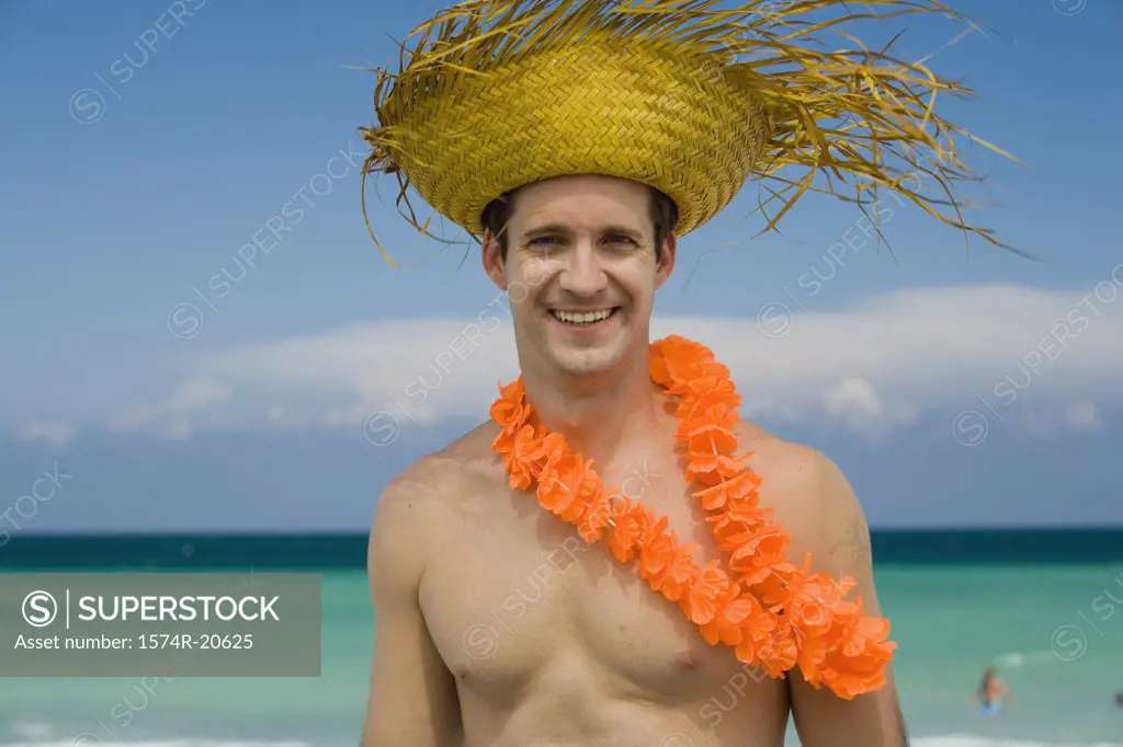 Portrait of a young man wearing a straw hat and smiling
