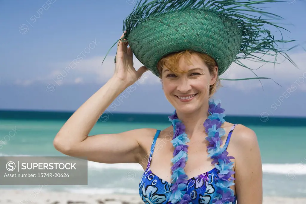 Portrait of a young woman wearing a straw hat and smiling