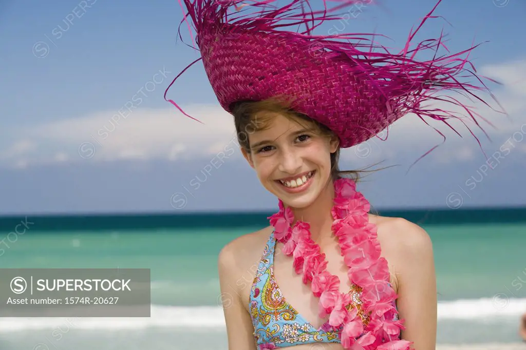 Portrait of a girl wearing a straw hat and smiling
