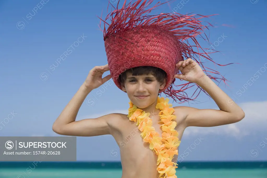 Portrait of a boy wearing a straw hat and smiling