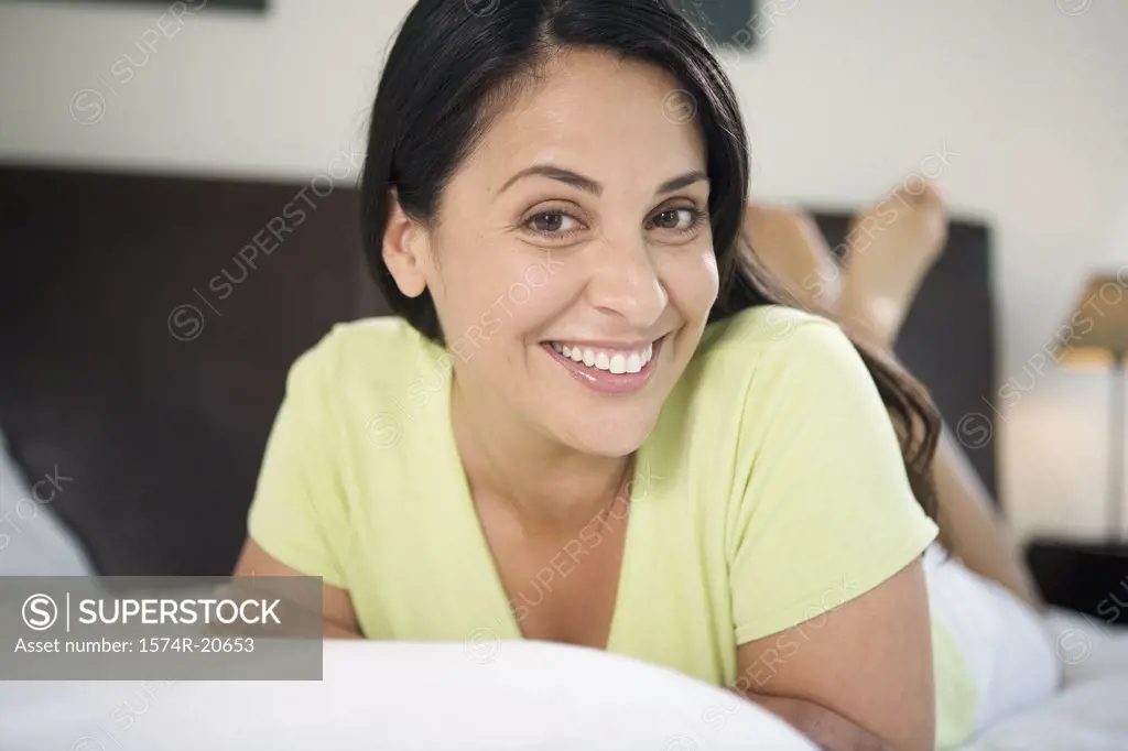 Portrait of a mature woman lying in the bed and smiling
