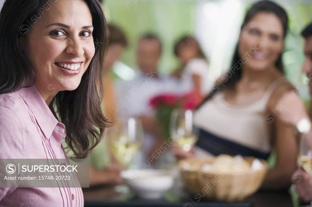 Portrait of a mature woman smiling with her friends in the background