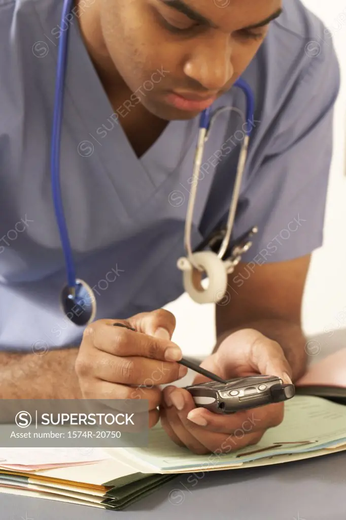 Close-up of a male doctor using a PDA