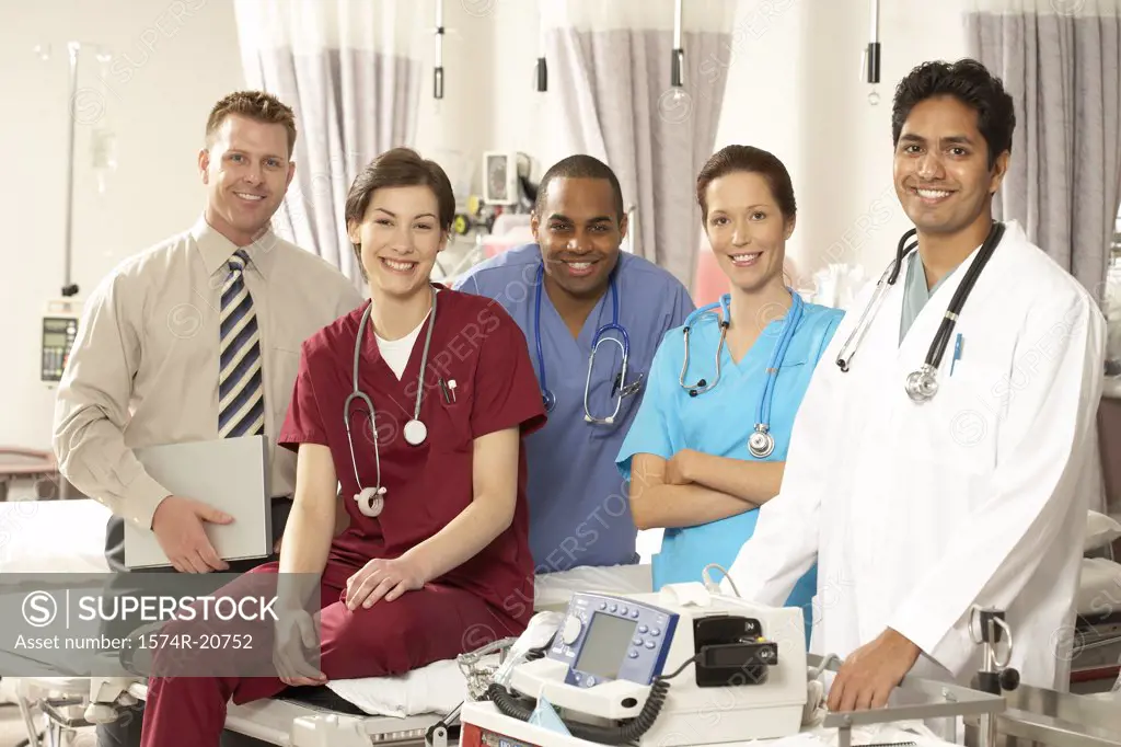 Three male doctors and two female doctors smiling