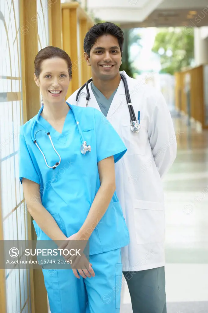 Female doctor and a male doctor smiling