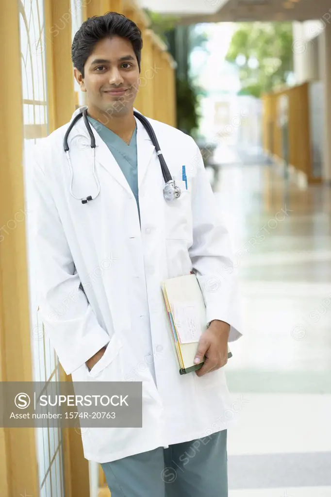 Male doctor standing in a corridor