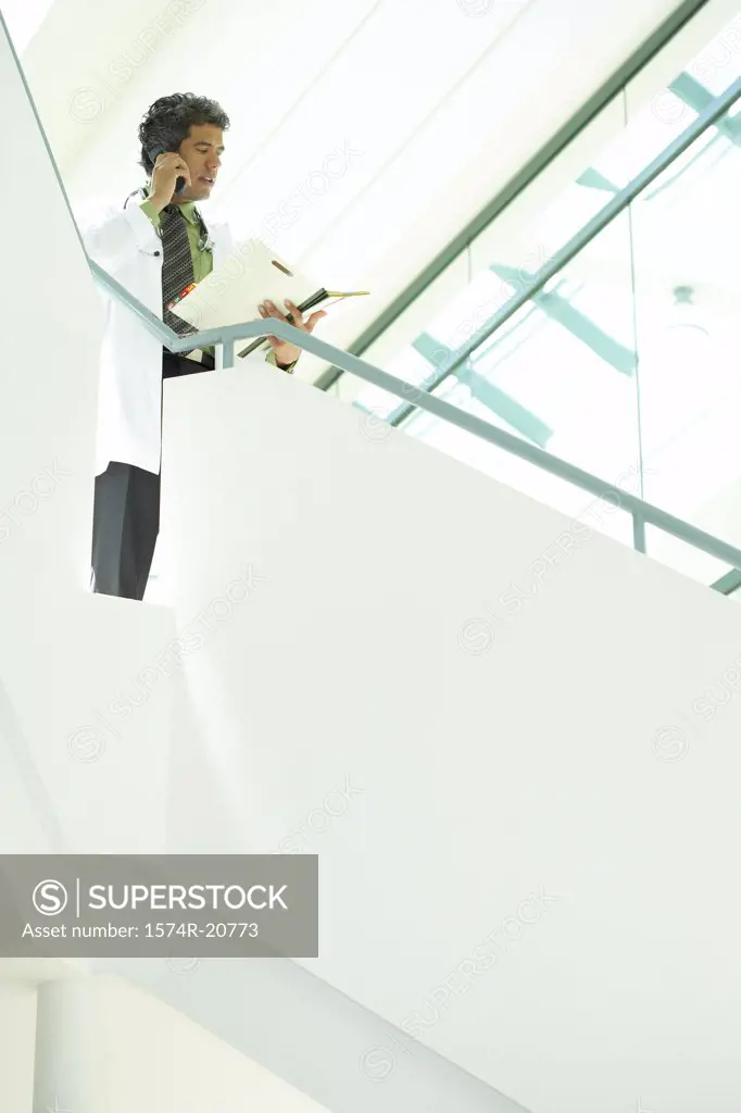 Low angle view of a male doctor talking on a mobile phone