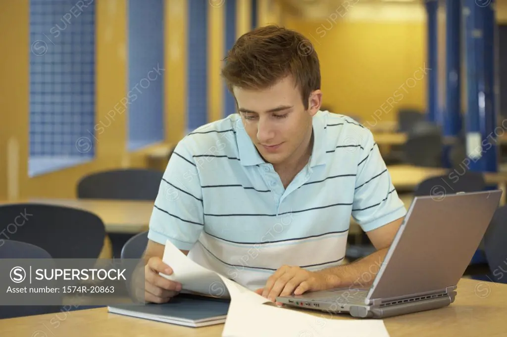 Close-up of a college student reading a paper