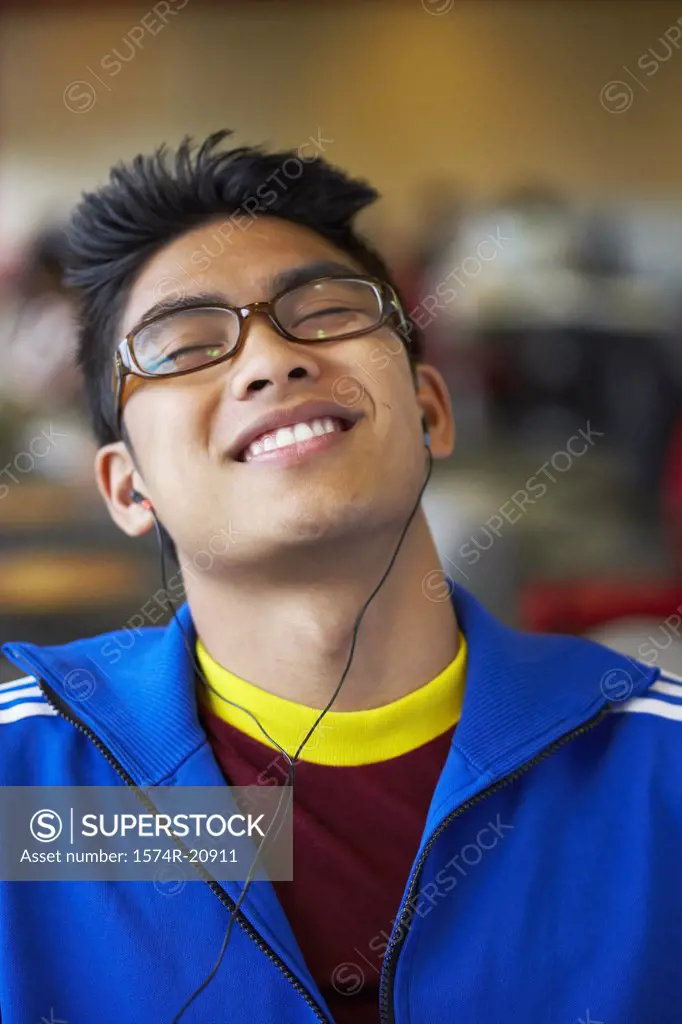 Close-up of a college student wearing headphones and listening to music