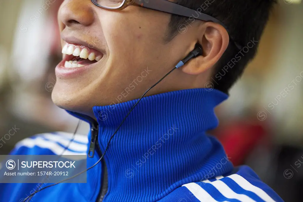 Close-up of a college student wearing headphones and listening to music