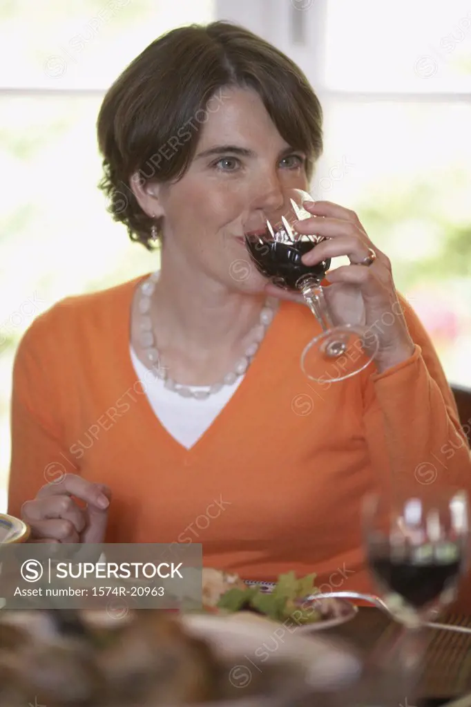 Close-up of a mid adult woman drinking red wine