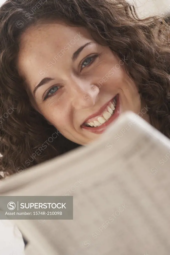 Close-up of a businesswoman reading a newspaper