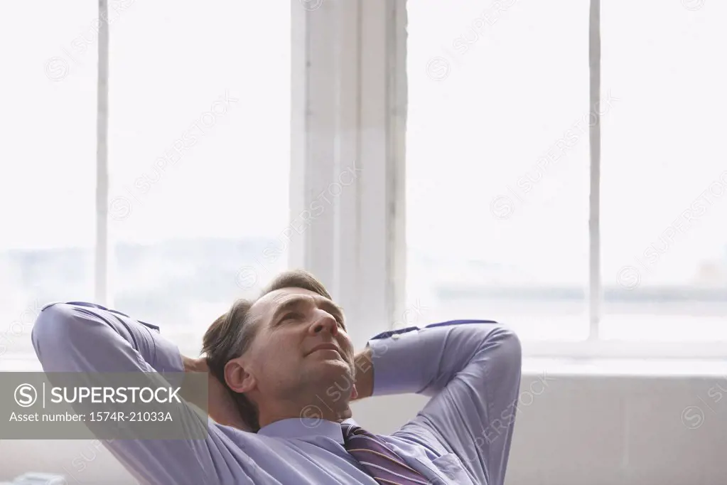 Businessman with his hands behind his head