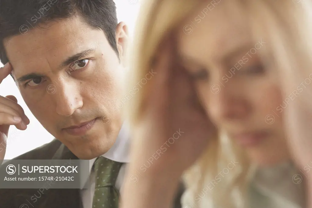 Close-up of a businessman looking at a businesswoman