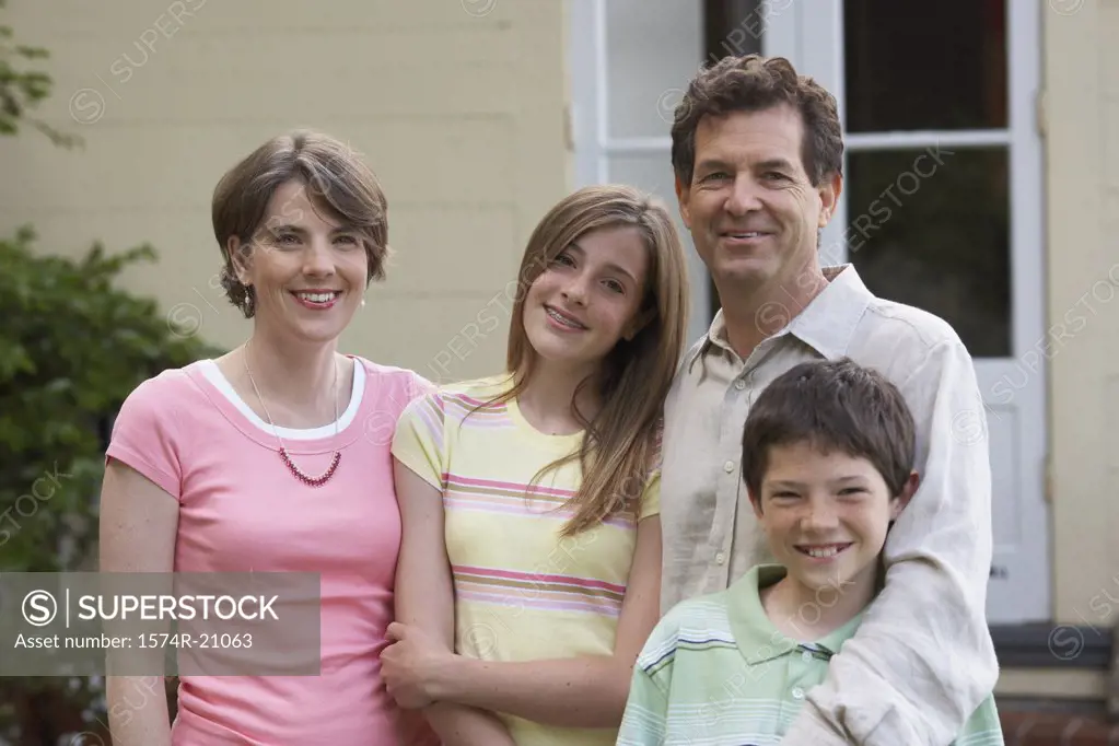 Mid adult couple smiling with their son and daughter