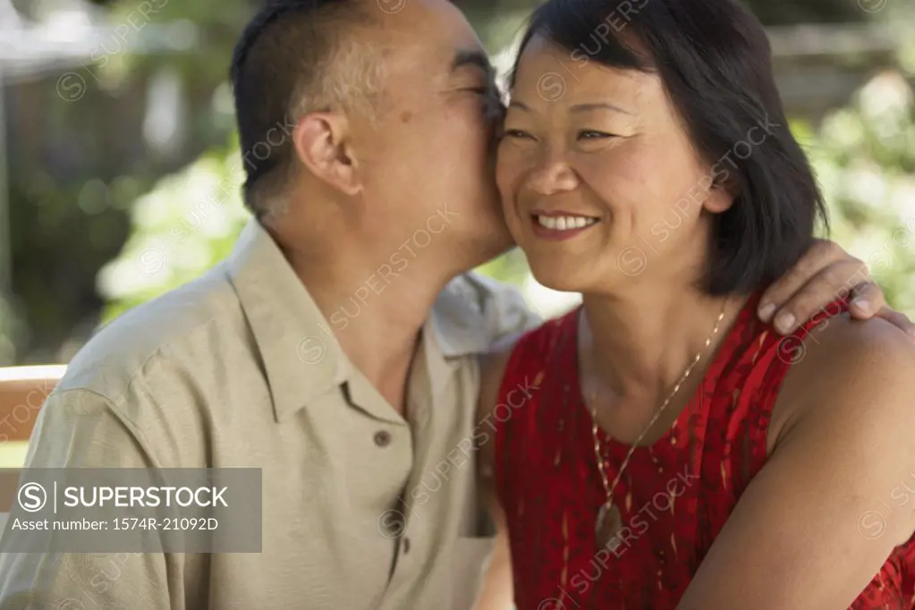 Close-up of a mature man kissing a mature woman