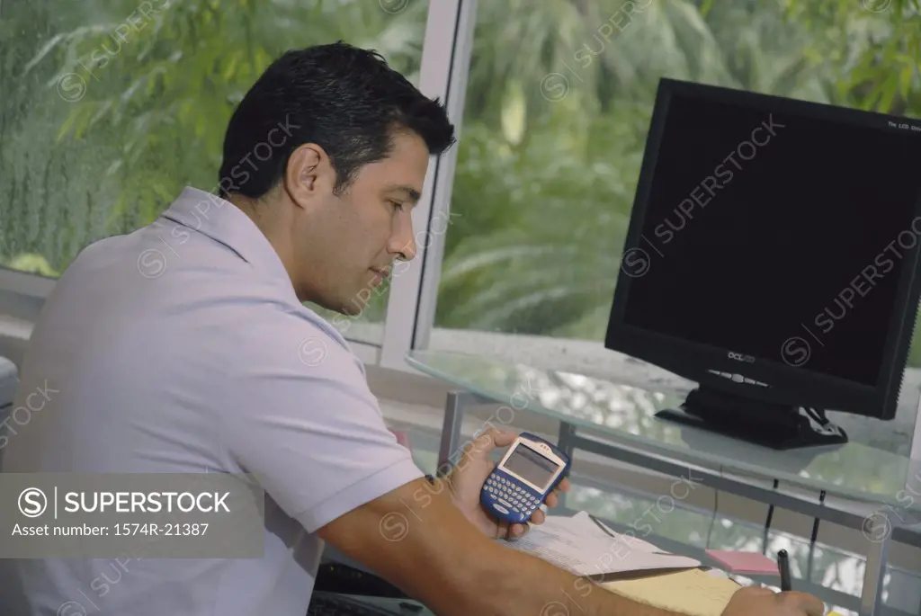 Side profile of a businessman sitting in front of a computer