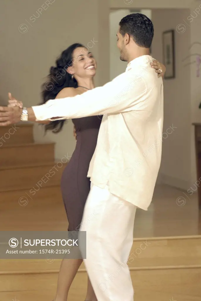 Side profile of a young couple dancing the tango