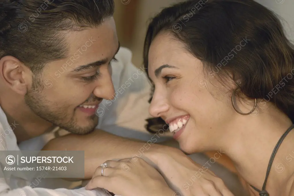 Close-up of a young couple smiling at each other