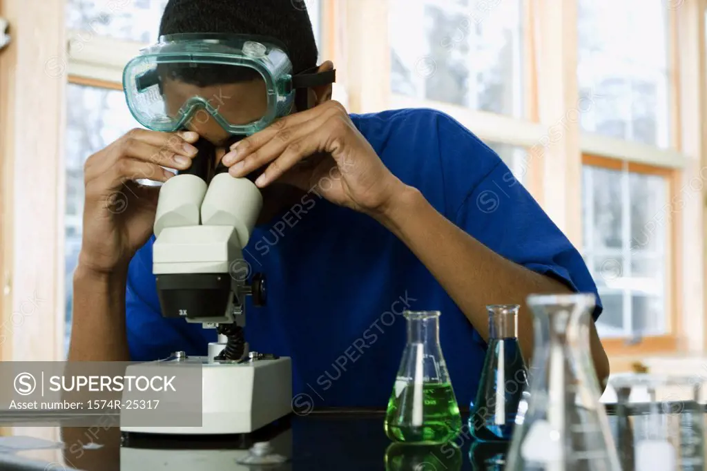 Student looking through a microscope in a science lab