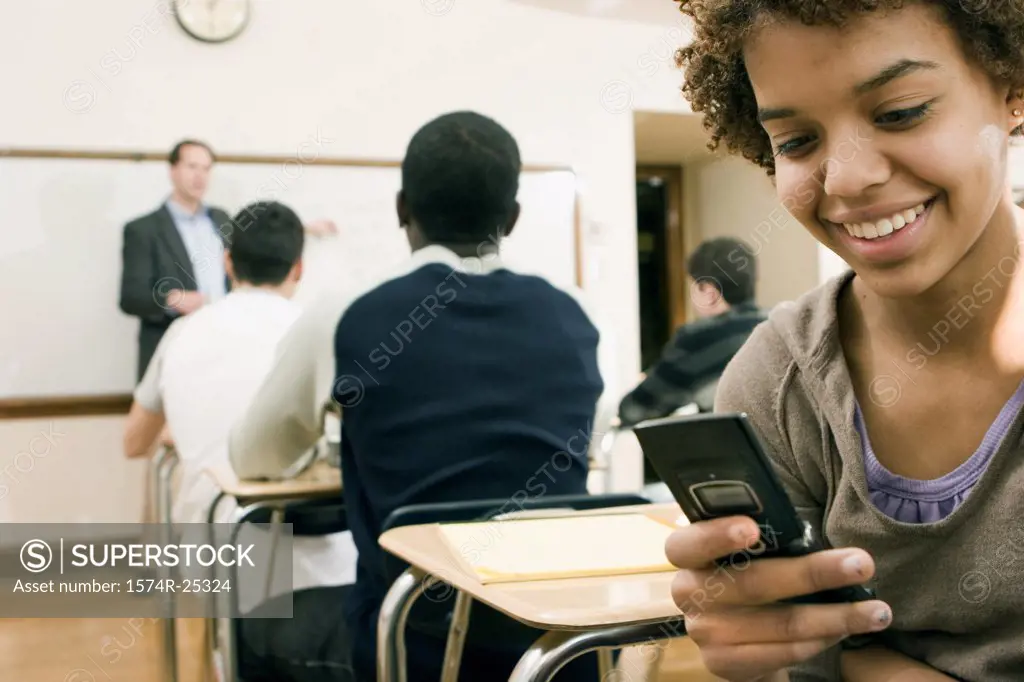 Student using a mobile phone in a classroom