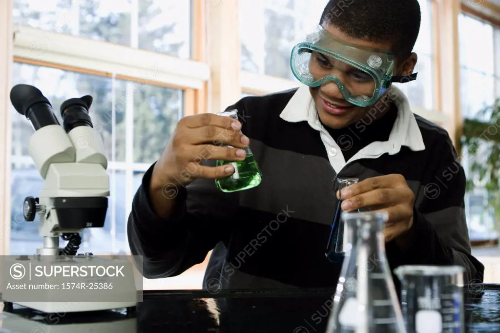 Student looking at a beaker in a science lab