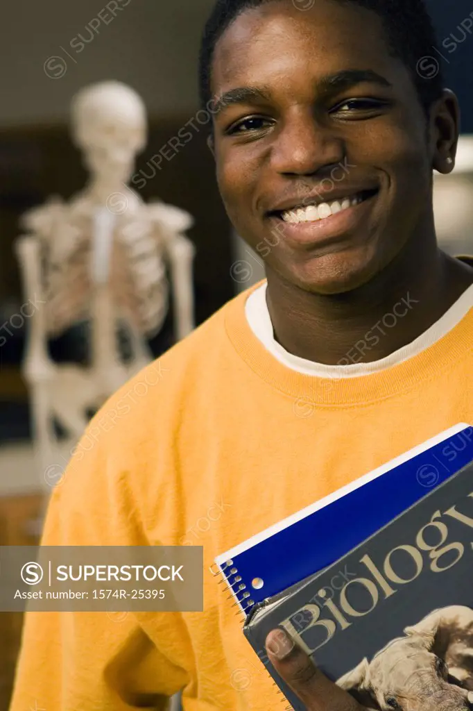 Portrait of a student holding books